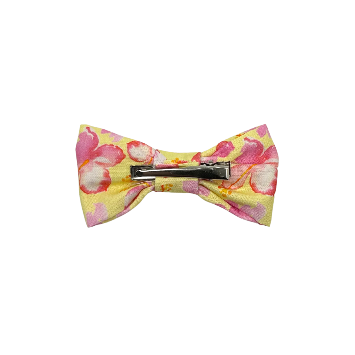 Floral patterned bow tie with a barrette on a white background
