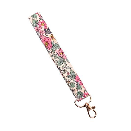 Floral patterned wristlet lanyard with a gold clasp on a white background