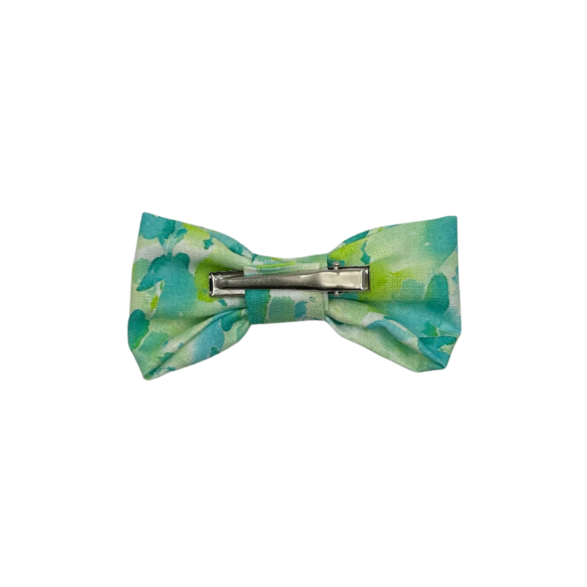 Green and blue patterned hair bow with a barrette on a white background